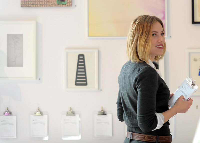 Woman in art gallery with clipboard