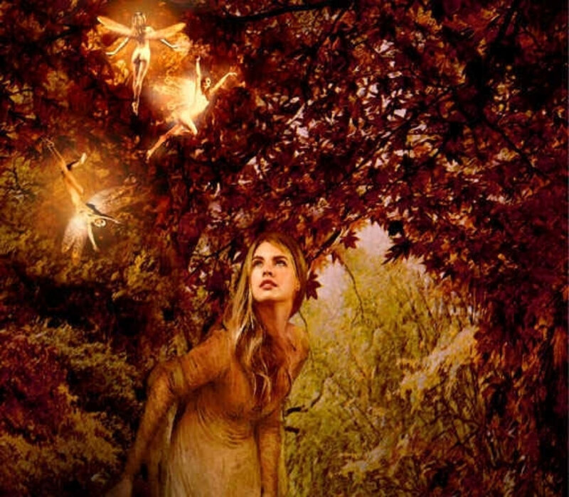 woman in autumn forest with fairies