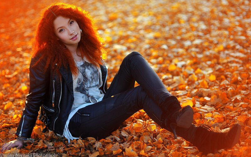 Woman in autumn leaves