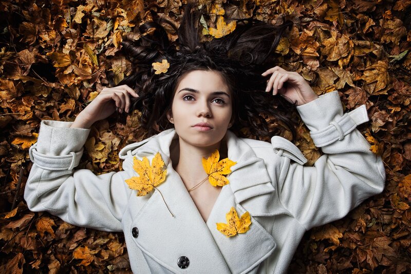 woman in autumn leaves