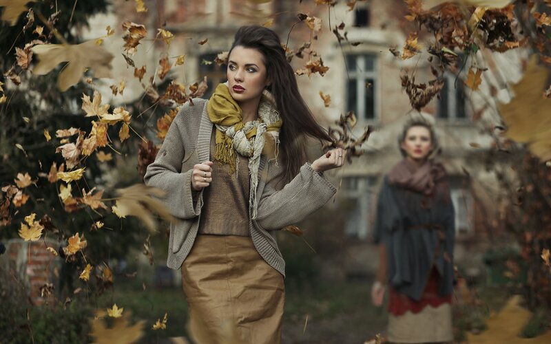 Woman in autumn leaves