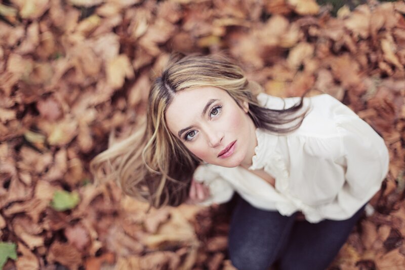 woman in autumn leaves