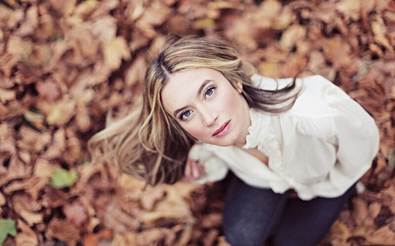 woman in autumn leaves