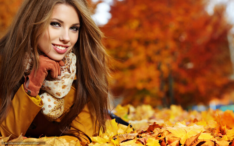 Woman in autumn leaves