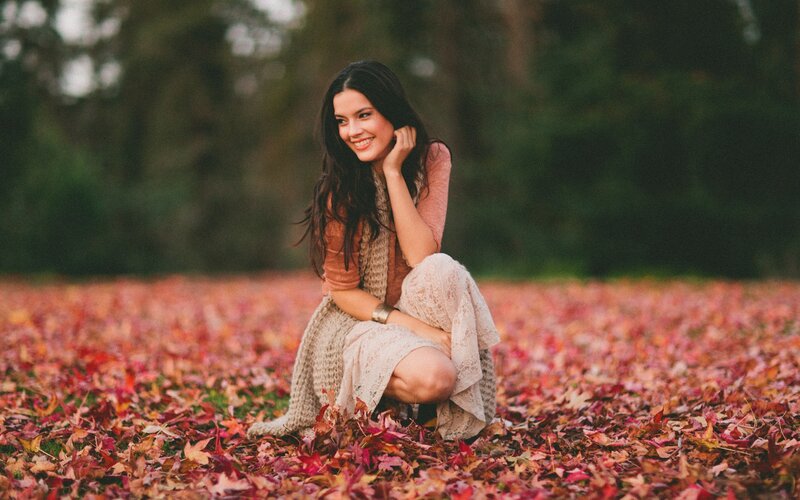 woman in autumn leaves