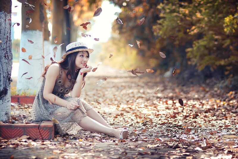Woman in autumn leaves