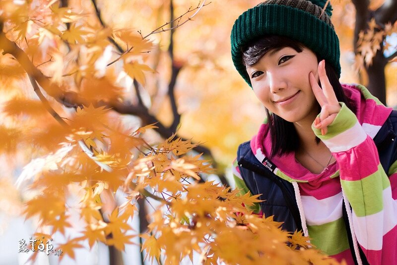 woman in autumn leaves