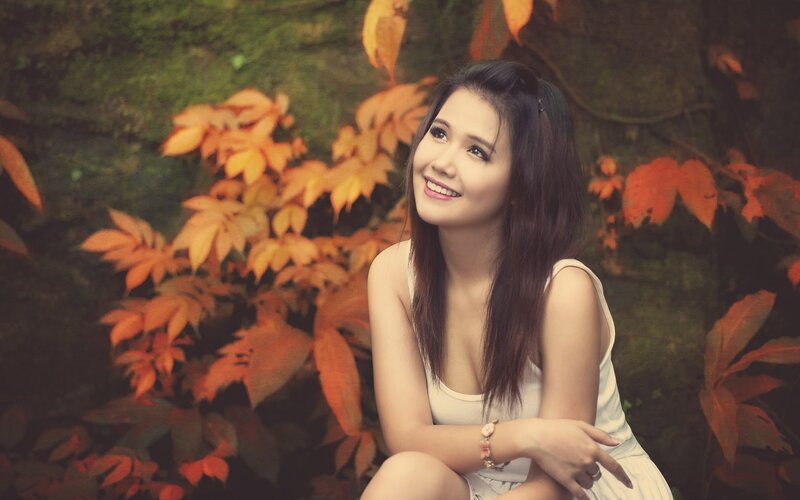 woman in autumn leaves