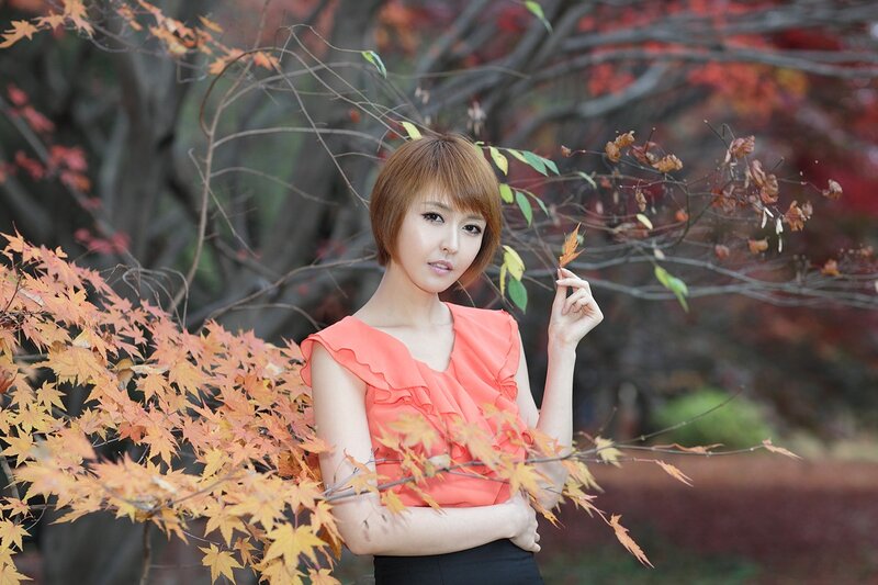 woman in autumn leaves