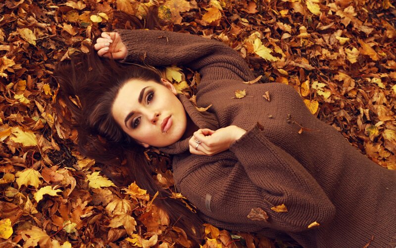 woman in autumn leaves