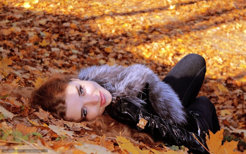 Woman in autumn leaves