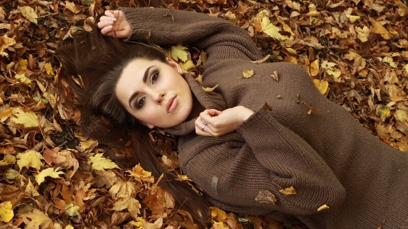 woman in autumn leaves