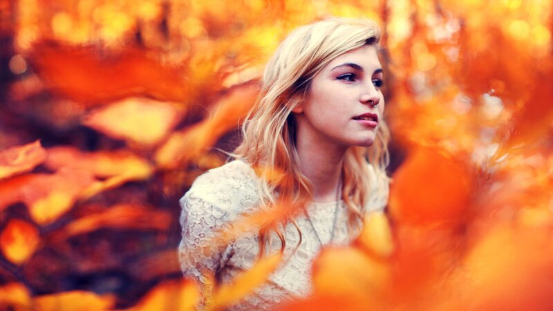 woman in autumn leaves