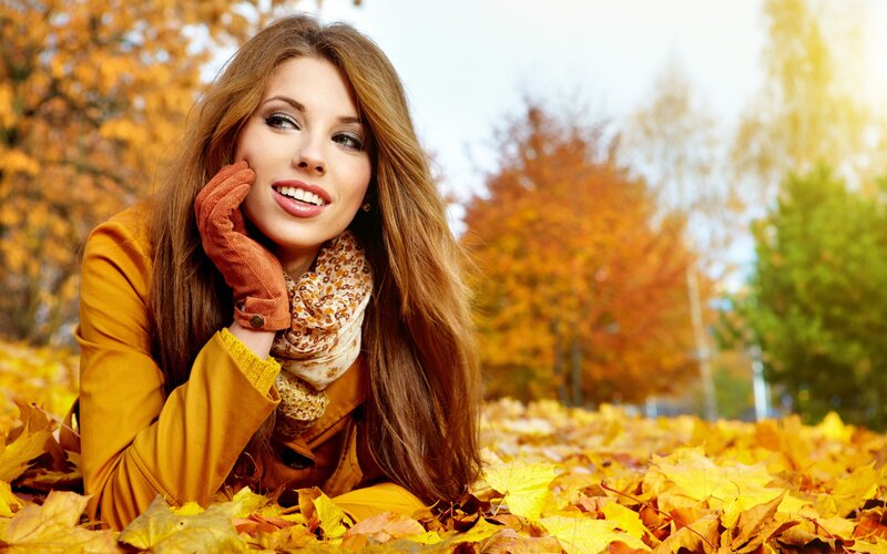 woman in autumn leaves