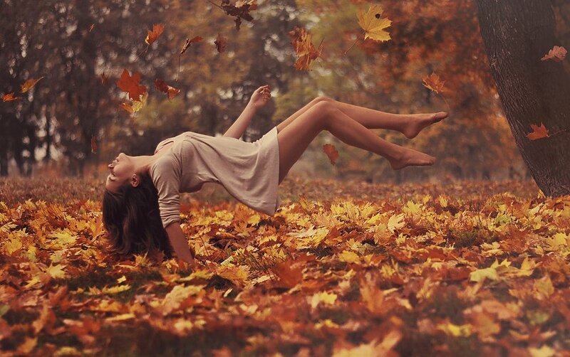 woman in autumn leaves