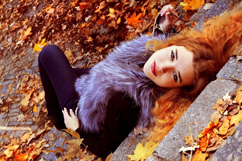 woman in autumn leaves