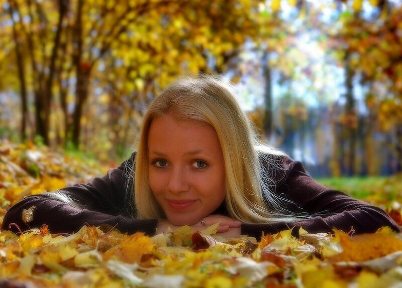 woman in autumn leaves