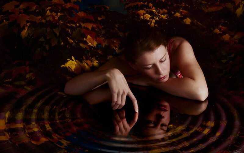 woman in autumn leaves