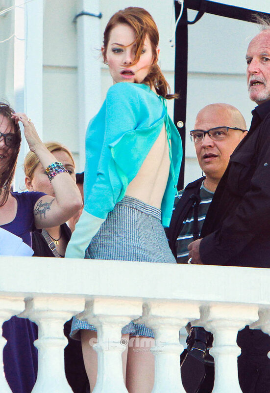 Woman in backless top on balcony