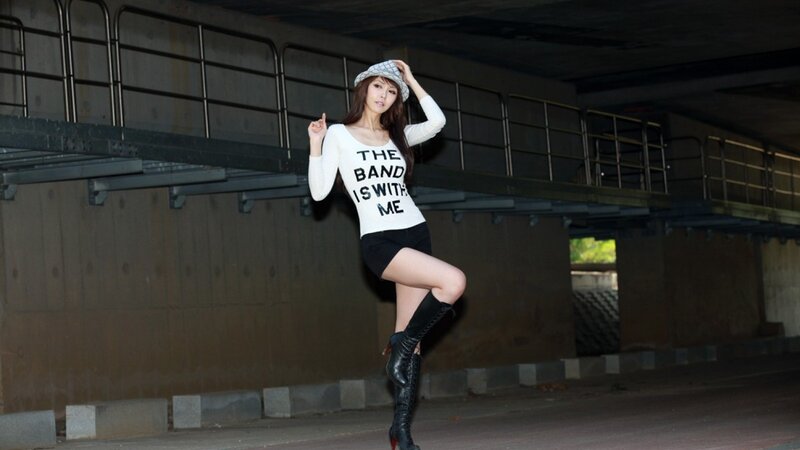 Woman in band t-shirt posing