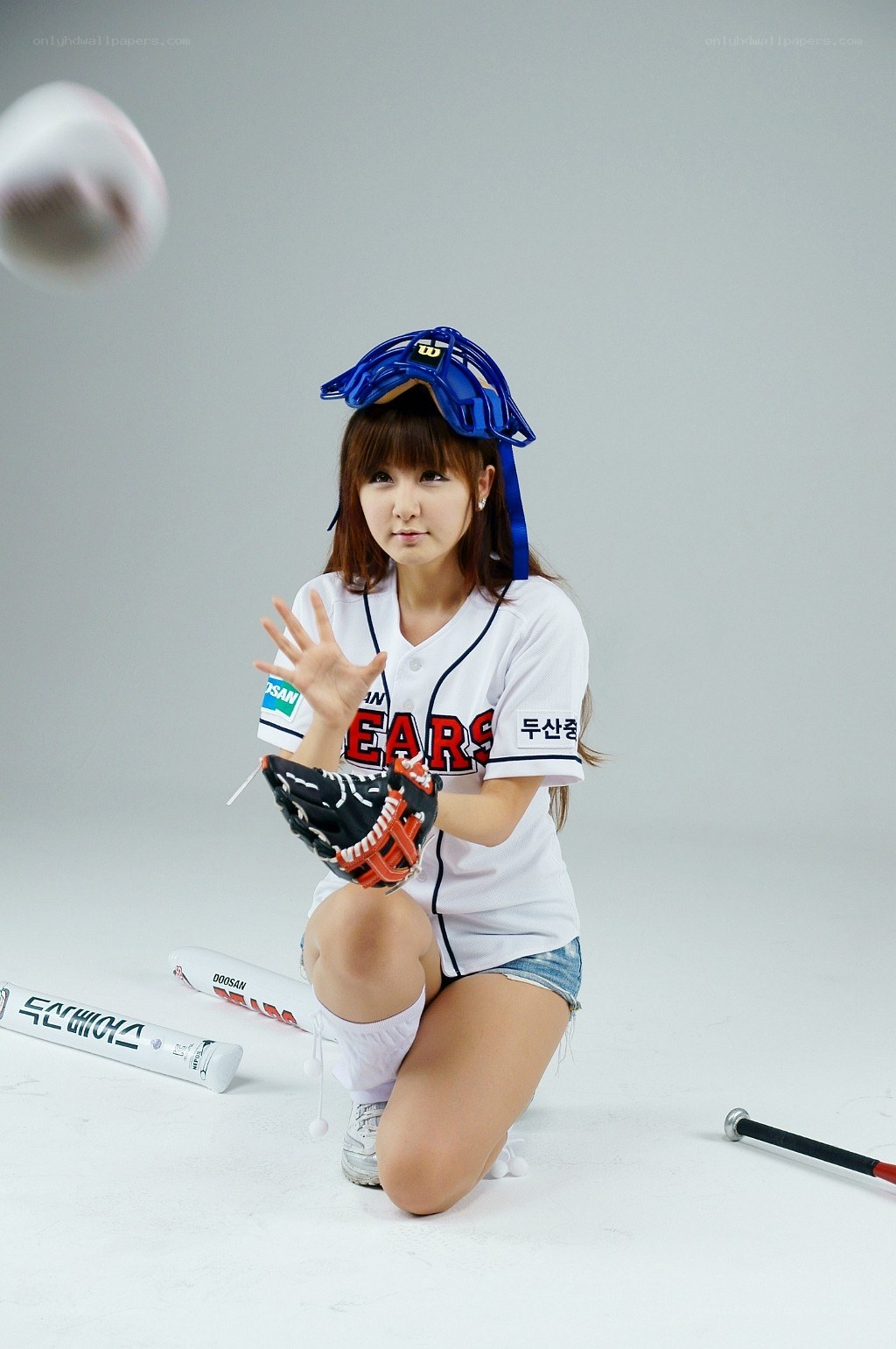 woman in baseball gear posing