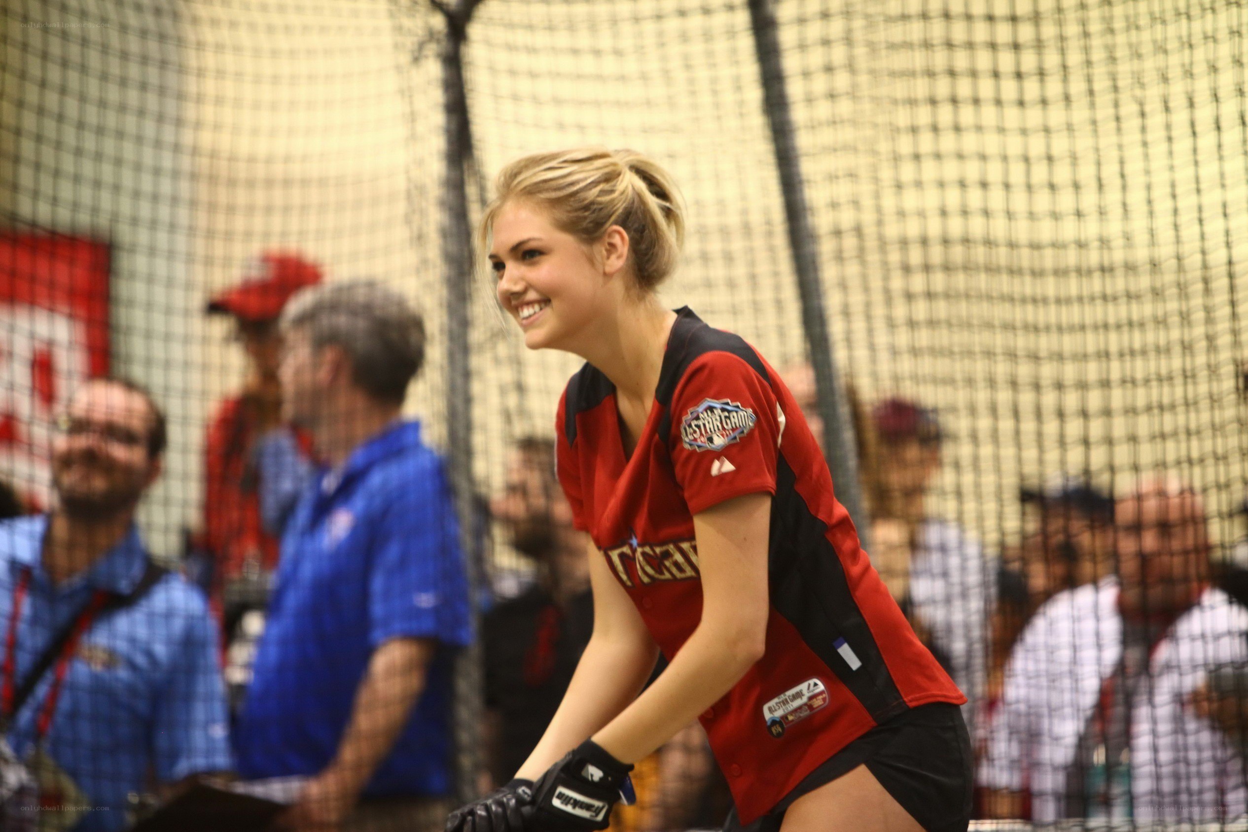 woman in baseball uniform smiling