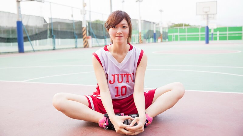 woman in basketball uniform on court