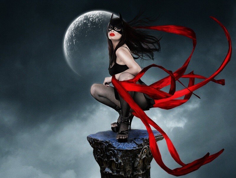 Woman in bat costume on pillar