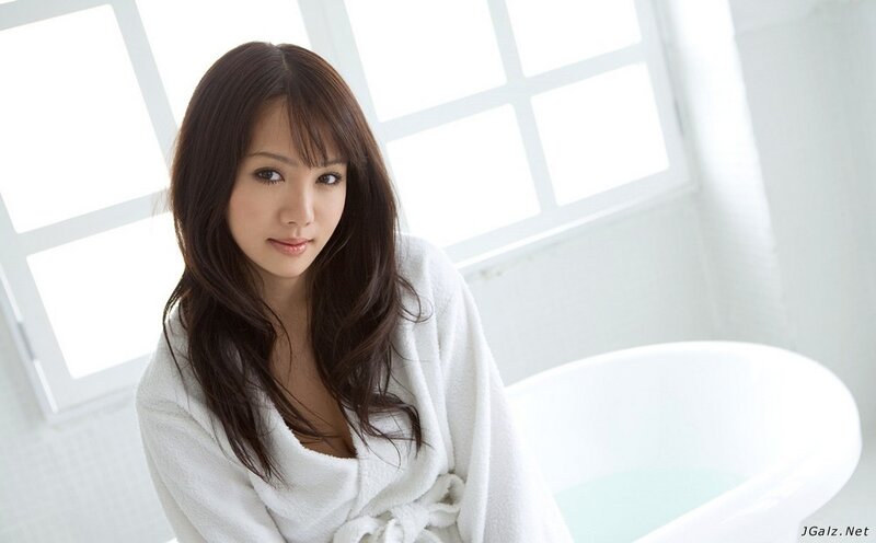 woman in bathrobe by bathtub
