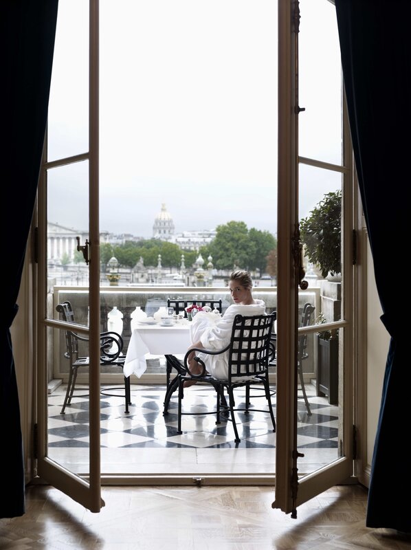 Woman in bathrobe on balcony