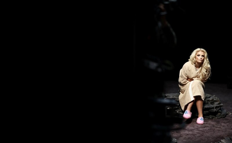 woman in bathrobe on stage
