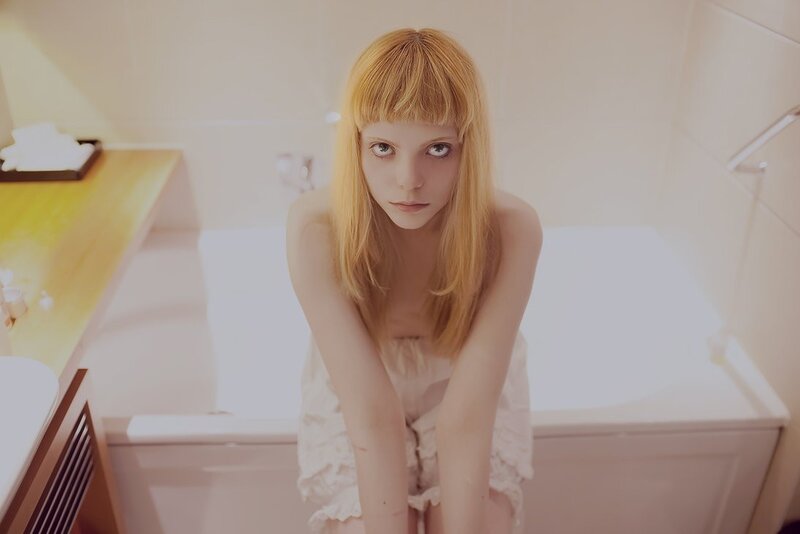 woman in bathroom looking at camera