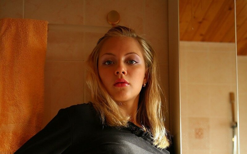 woman in bathroom looking at camera