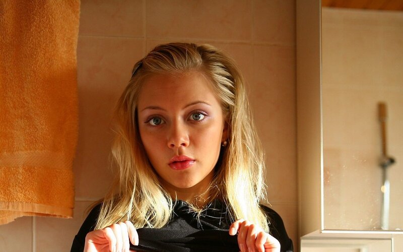 woman in bathroom looking at camera