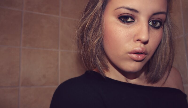 woman in bathroom looking at camera