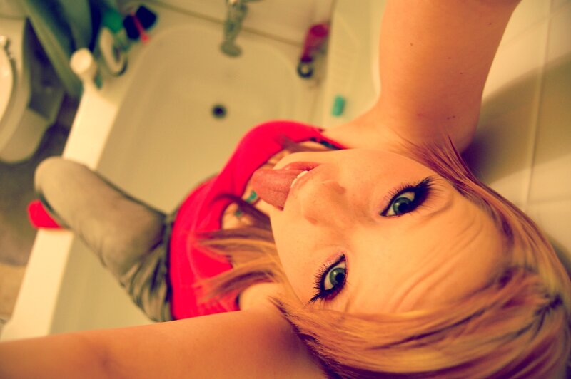 woman in bathroom making face