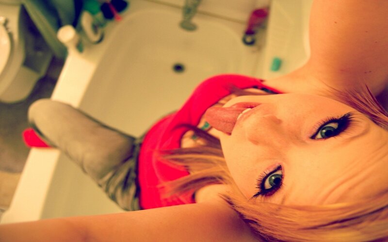 woman in bathroom taking selfie