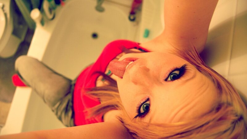 woman in bathtub making face