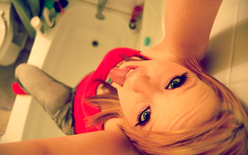 woman in bathtub making face