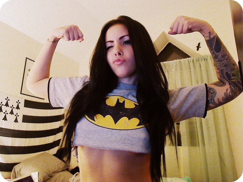 woman in batman shirt flexing