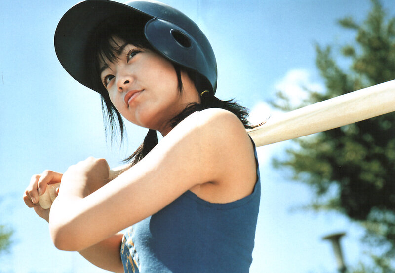 woman in batting helmet holding bat