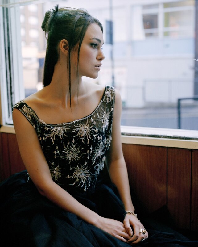 woman in beaded dress by window