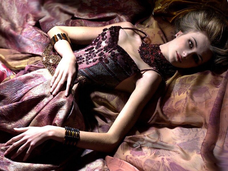 woman in beaded dress lying down