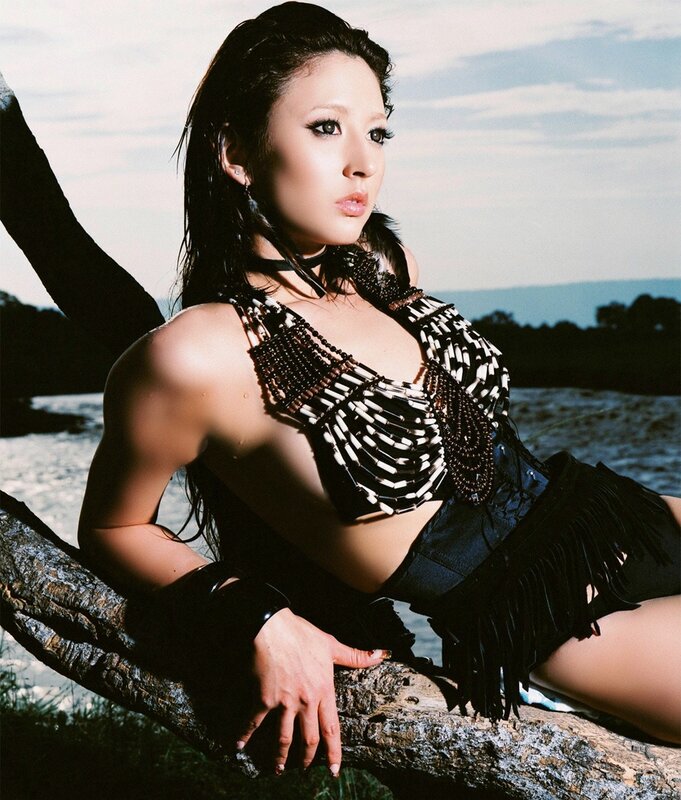 woman in beaded top by water