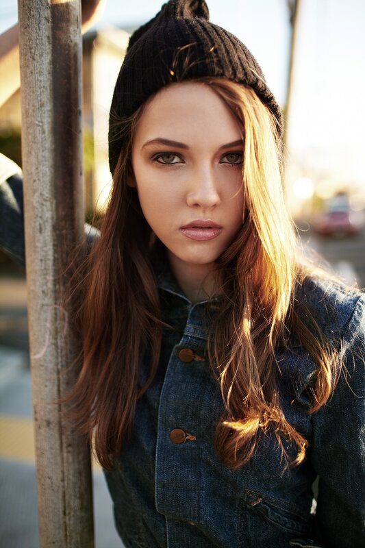 woman in beanie and denim jacket