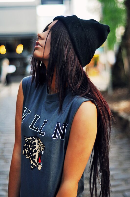 woman in beanie and graphic tee