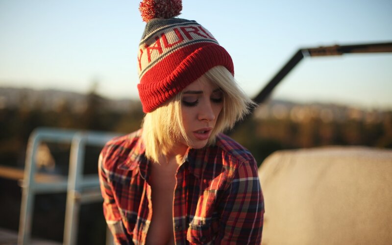woman in beanie and plaid shirt
