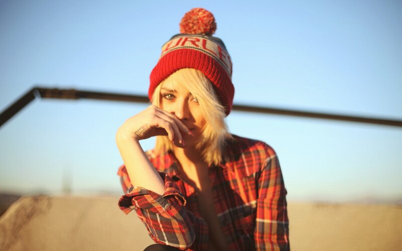 woman in beanie and plaid shirt