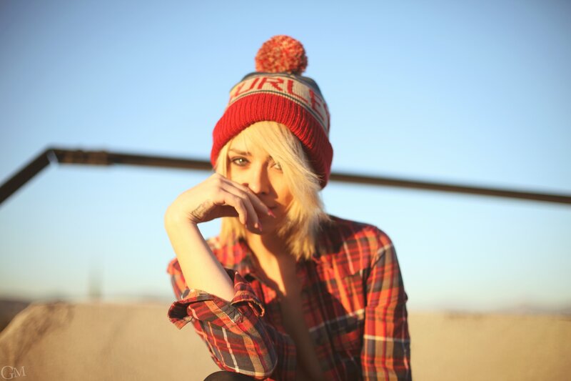 woman in beanie and plaid shirt