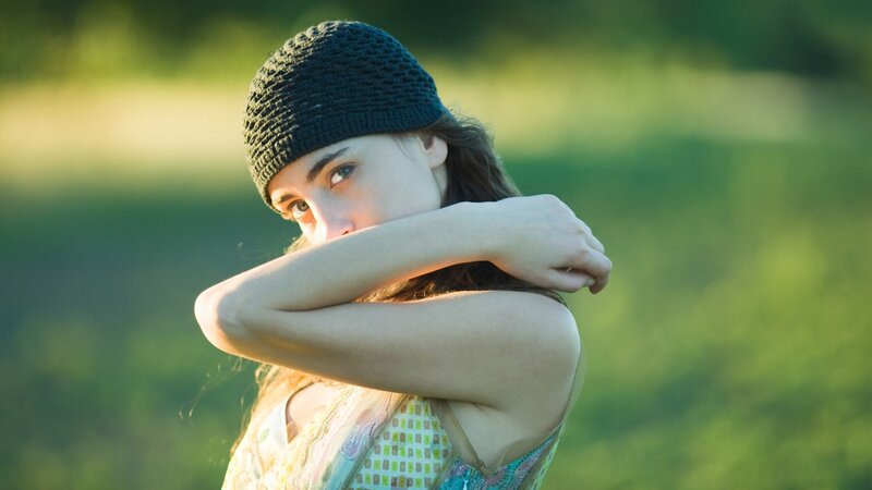 woman in beanie covering face